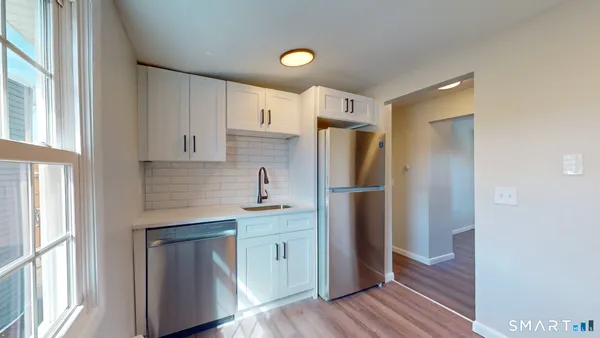 a kitchen with stainless steel appliances granite countertop a refrigerator and a sink
