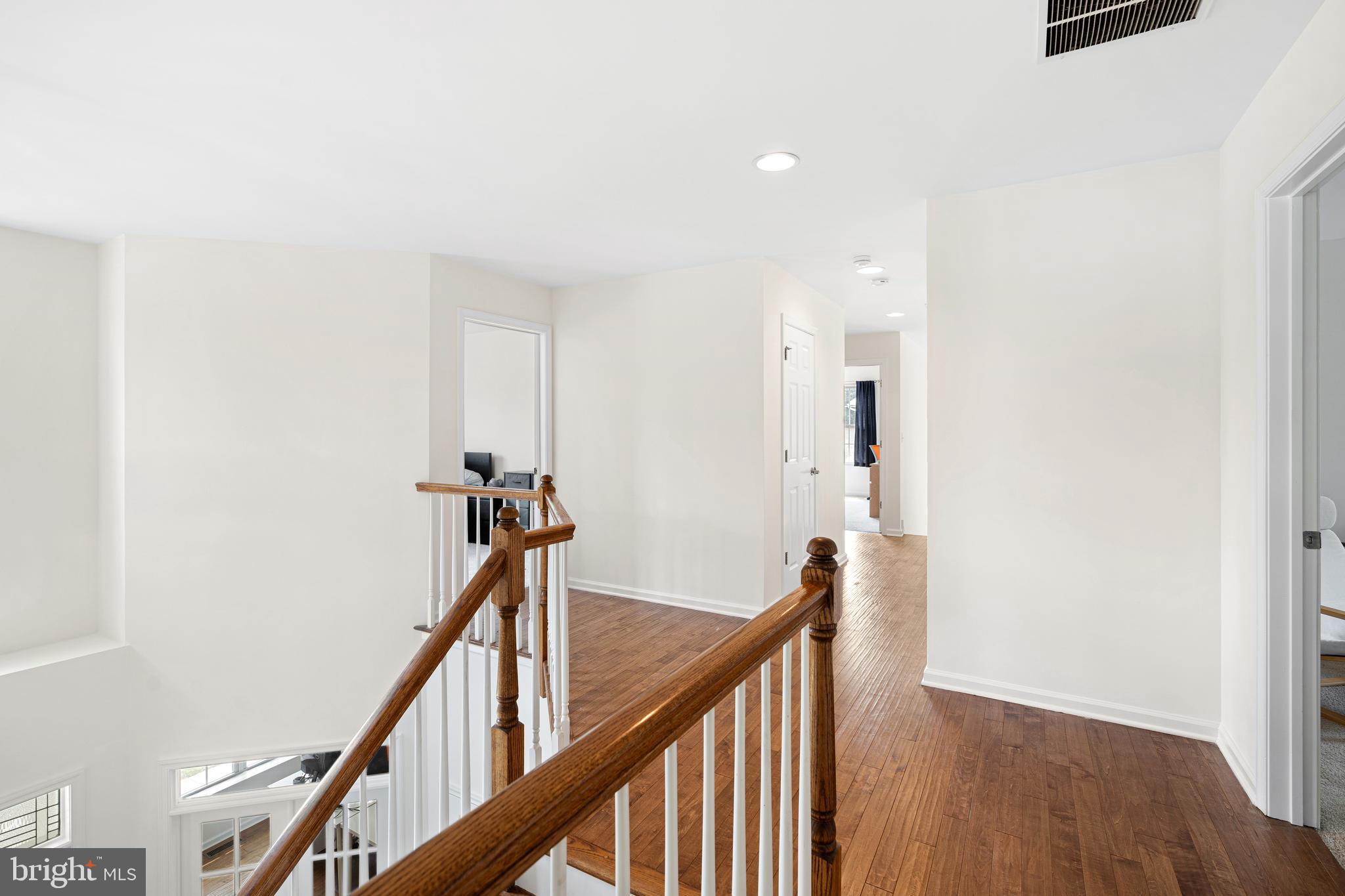 39 Brandon Road West Pennington, NJ 08534 - Photo 36 of 48 a view of a hallway with wooden floor and stairs