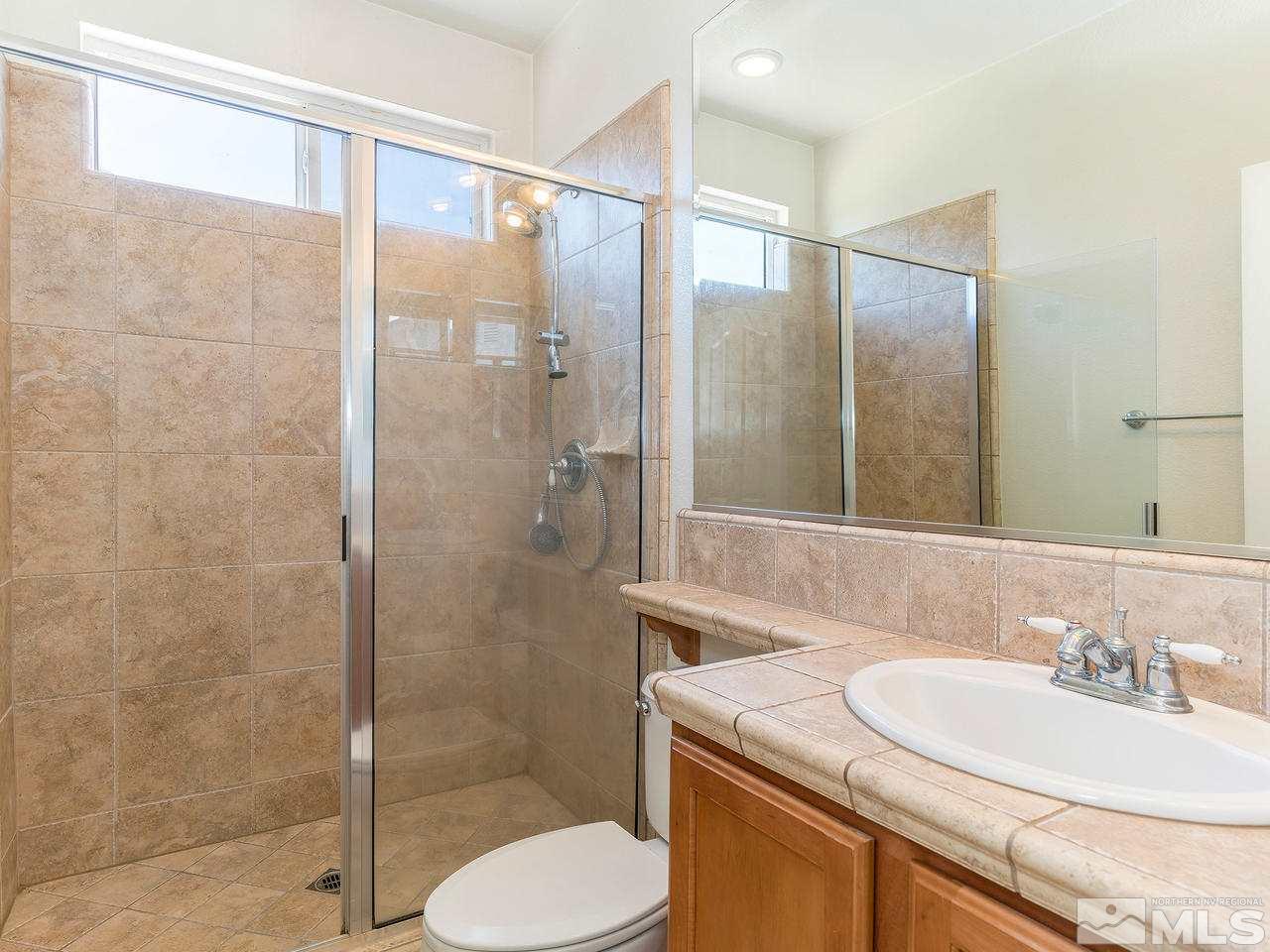 13665 Dressage Court Reno, NV 89521 - Photo 21 of 22 a bathroom with a sink toilet and shower