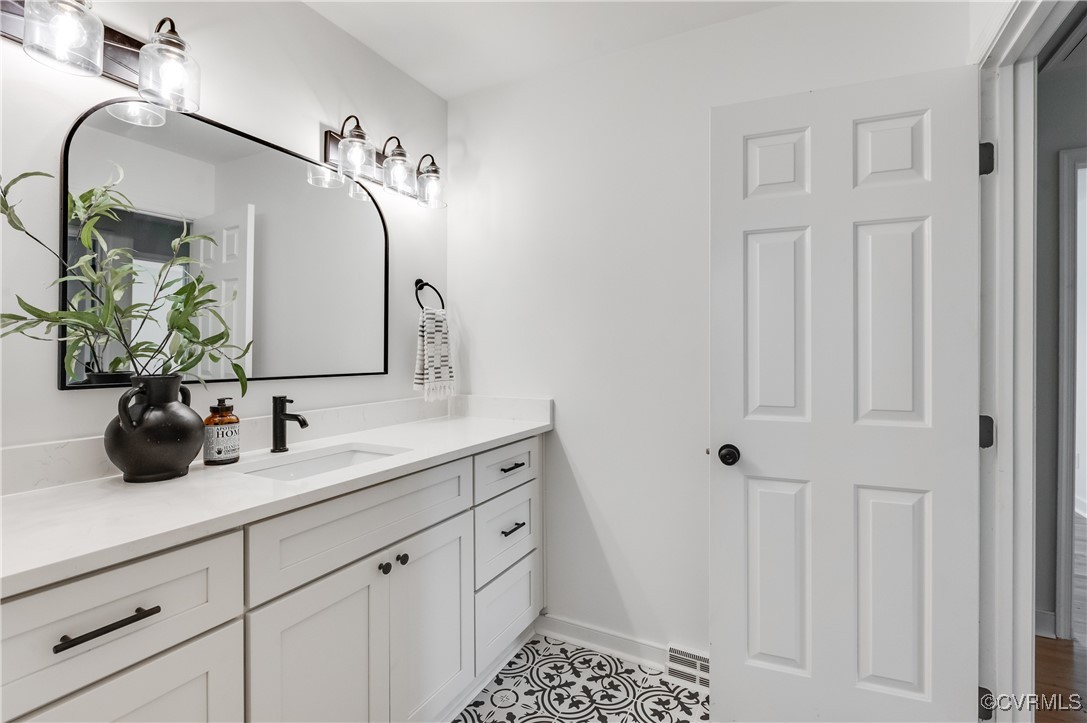 2840 Osborne Road Chester, VA 23831 - Photo 32 of 42 a bathroom with a double vanity sink a mirror a vanity and