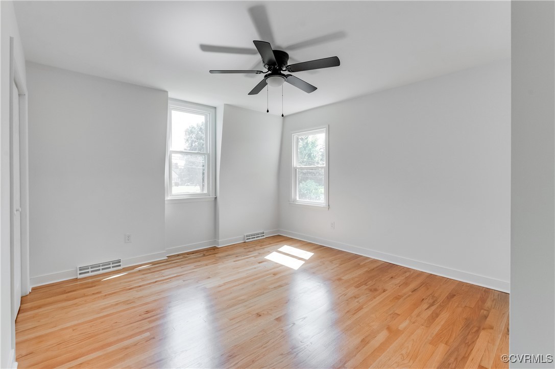 2840 Osborne Road Chester, VA 23831 - Photo 34 of 42 an empty room with wooden floor a ceiling fan and windows