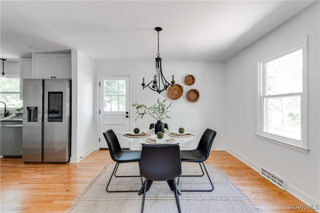 2840 Osborne Road Chester, VA 23831 - Photo 8 of 42 a dining room with furniture a chandelier and wooden floor