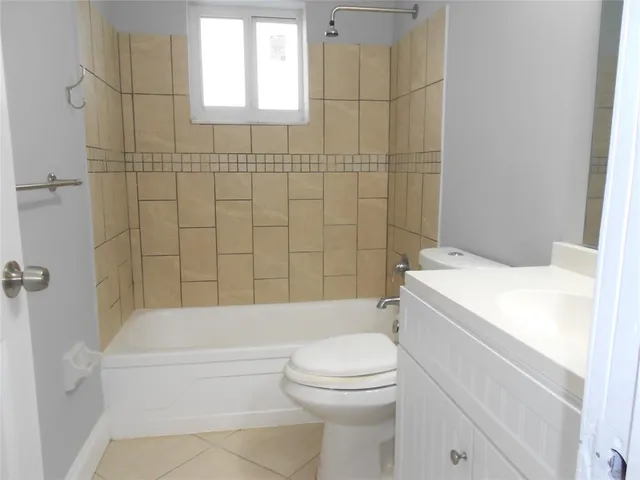 a bathroom with a toilet and a bath tub