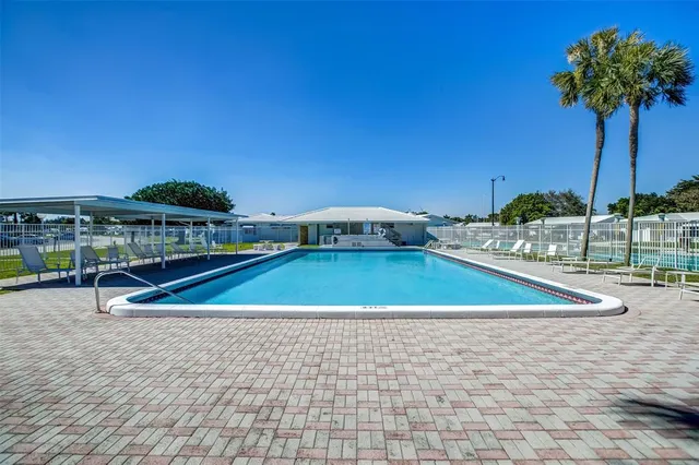 a view of a tennis court with a small pool