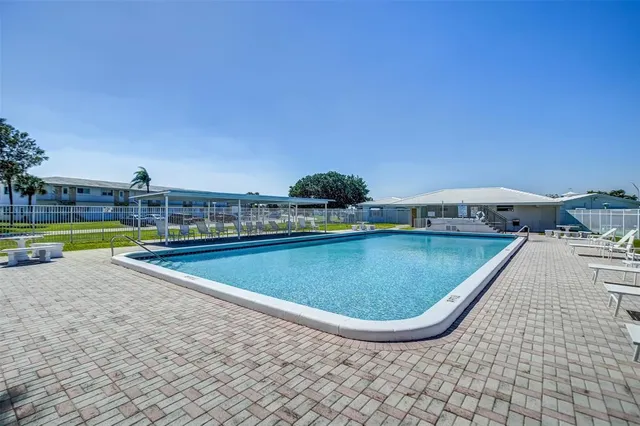 a view of a swimming pool with a lounge chair