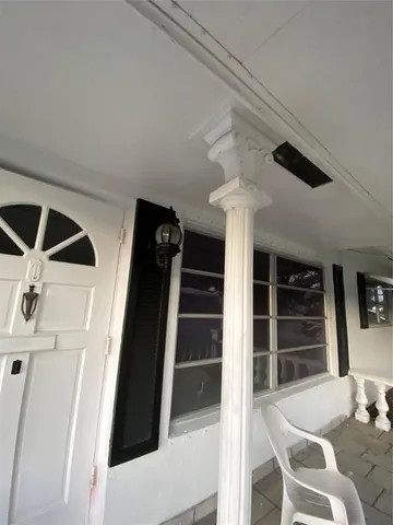 a view of a hallway with seating space