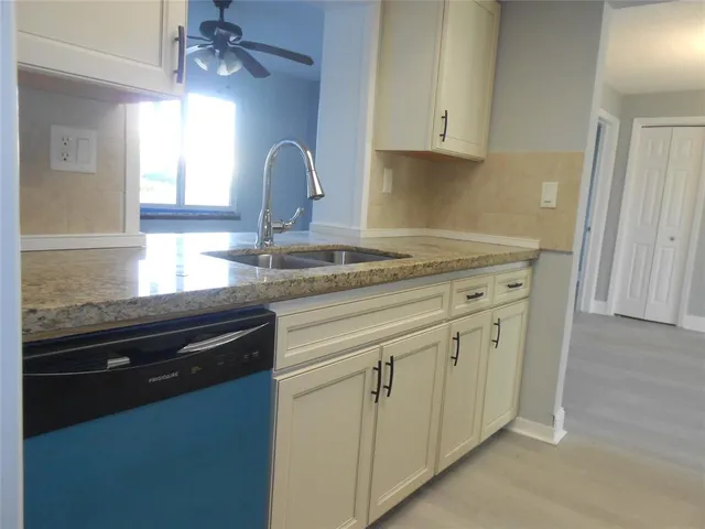 a kitchen with granite countertop white cabinets and a granite counter tops