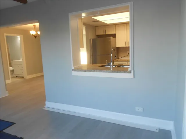 a kitchen with appliances a sink and cabinets