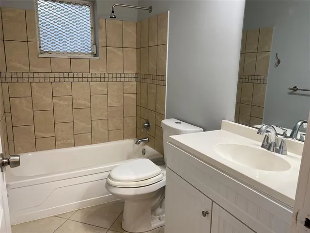 a bathroom with a toilet a sink and bathtub