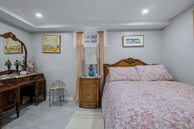 a bedroom with a bed and a dresser in it