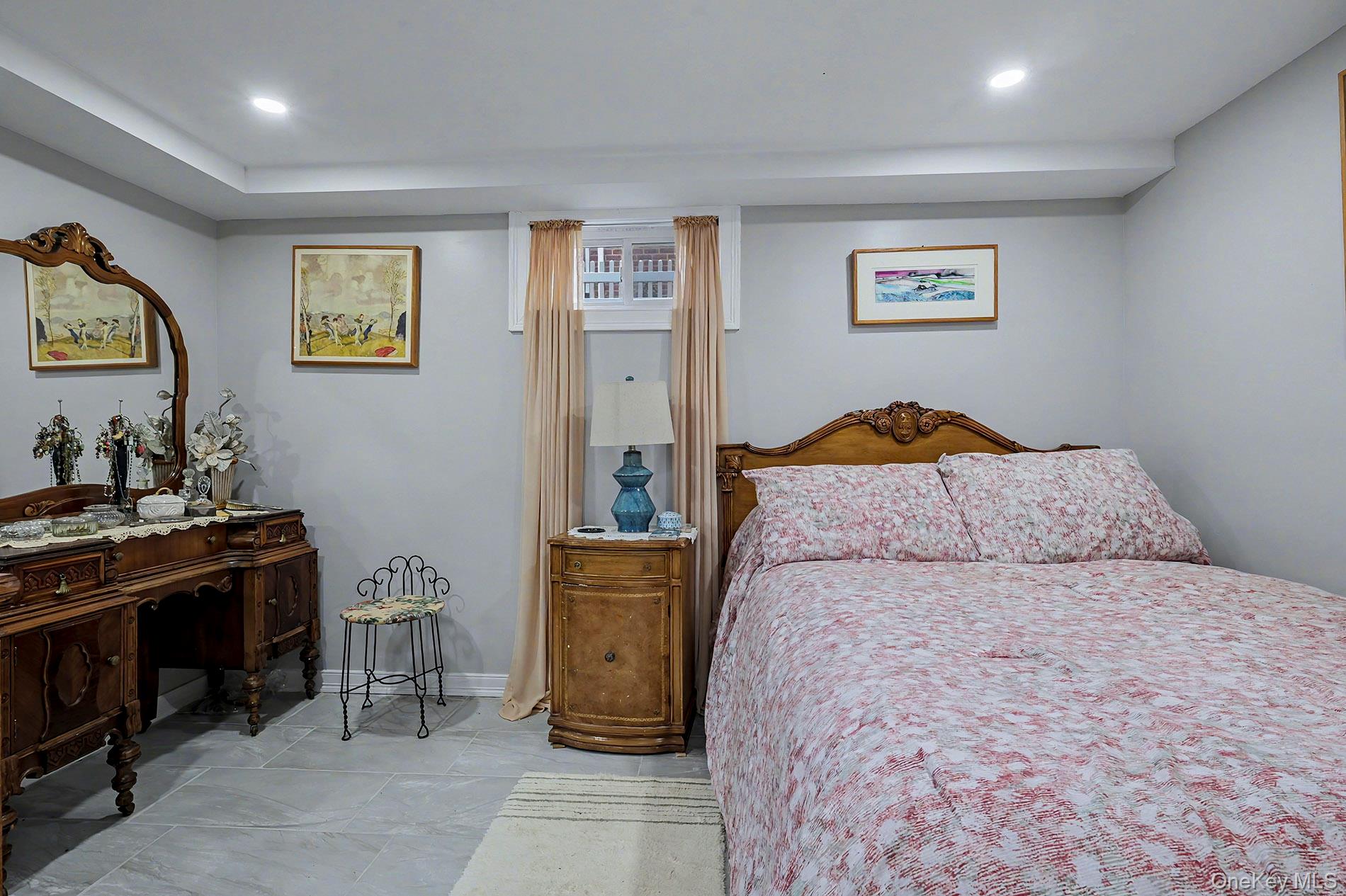 24 Cedar Road Westbury, NY 11590 - Photo 14 of 22 a bedroom with a bed and a dresser in it