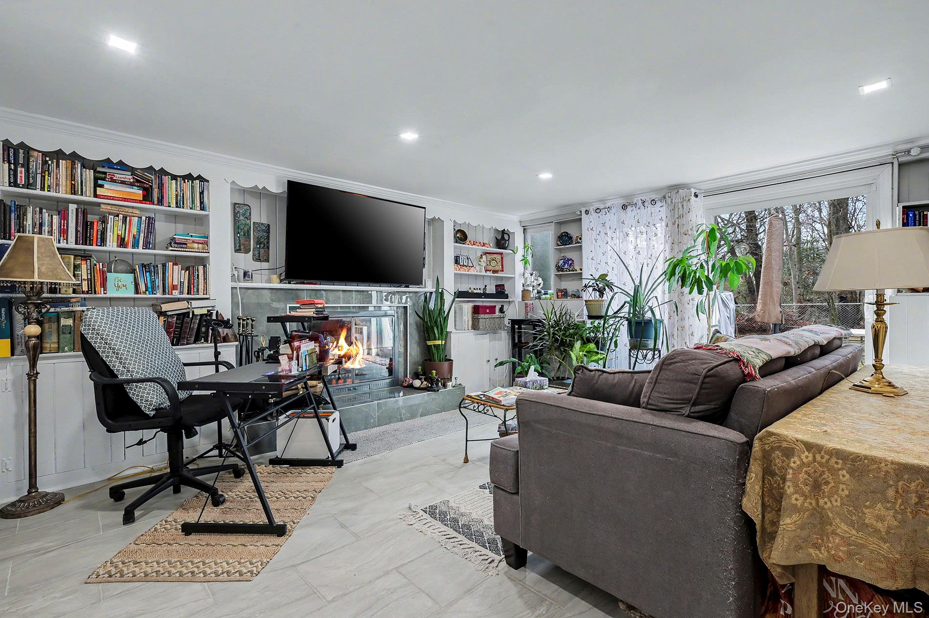 24 Cedar Road Westbury, NY 11590 - Photo 15 of 22 a living room with furniture and a flat screen tv