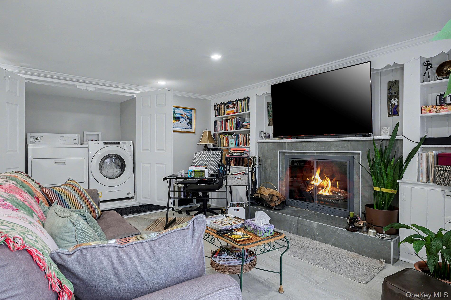 24 Cedar Road Westbury, NY 11590 - Photo 16 of 22 a living room with fireplace furniture and a flat screen tv