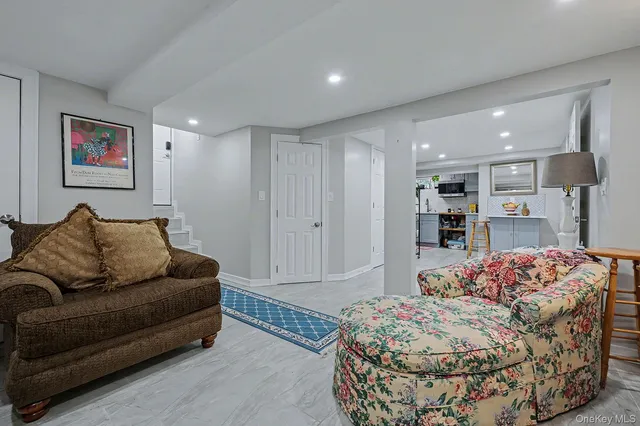 a living room with a couch and a book shelf