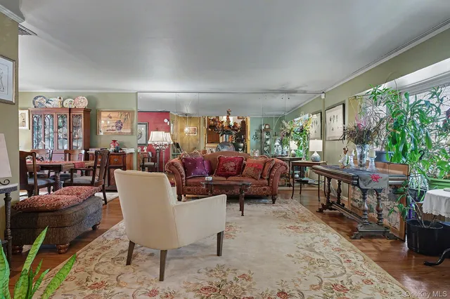 a living room with furniture a flat screen tv and a large window