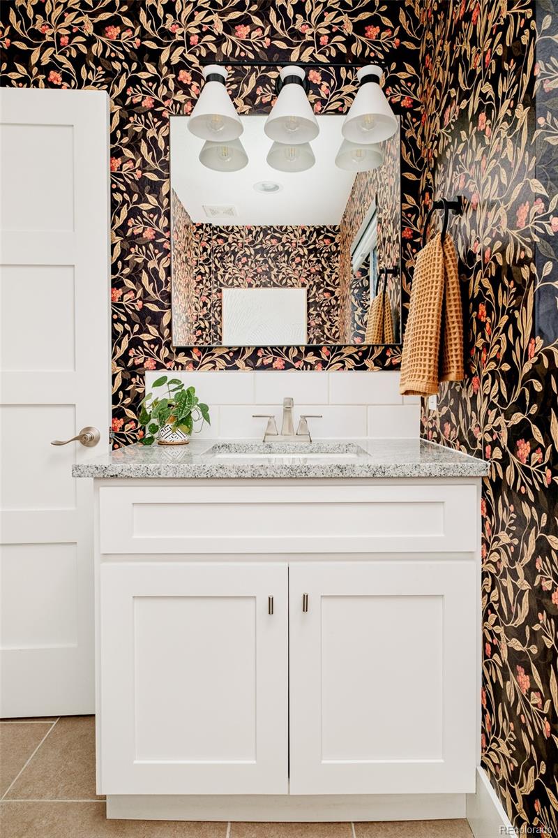 2048 Meade Street Denver, CO 80211 - Photo 12 of 50 a bathroom with a sink and a mirror