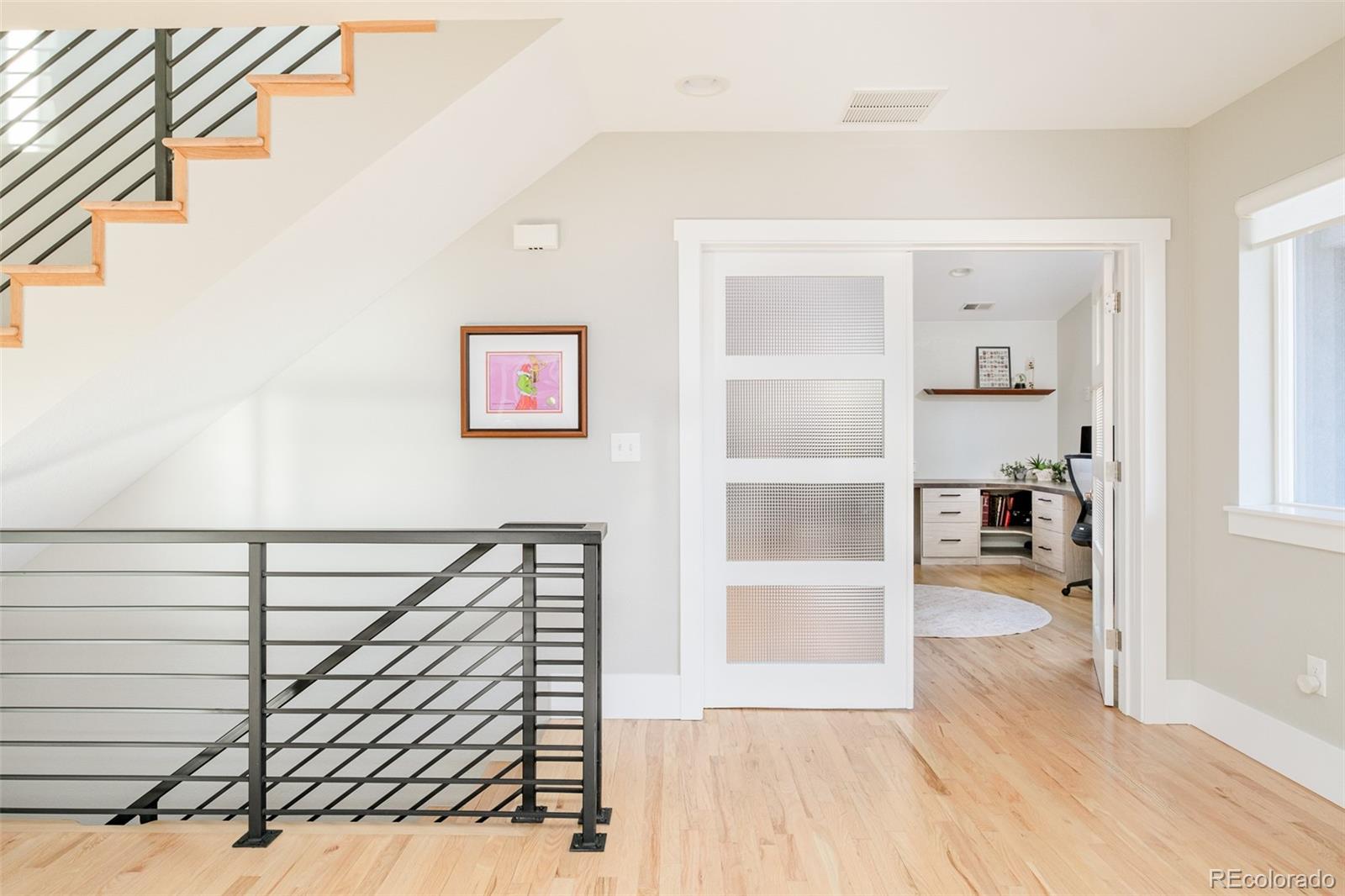 2048 Meade Street Denver, CO 80211 - Photo 25 of 50 a view of a hallway with wooden floor and windows