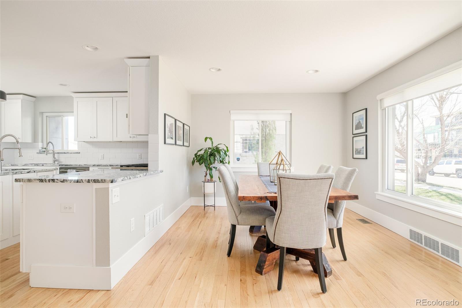 2048 Meade Street Denver, CO 80211 - Photo 3 of 50 a dining room with granite countertop wooden floor and a granite counter top
