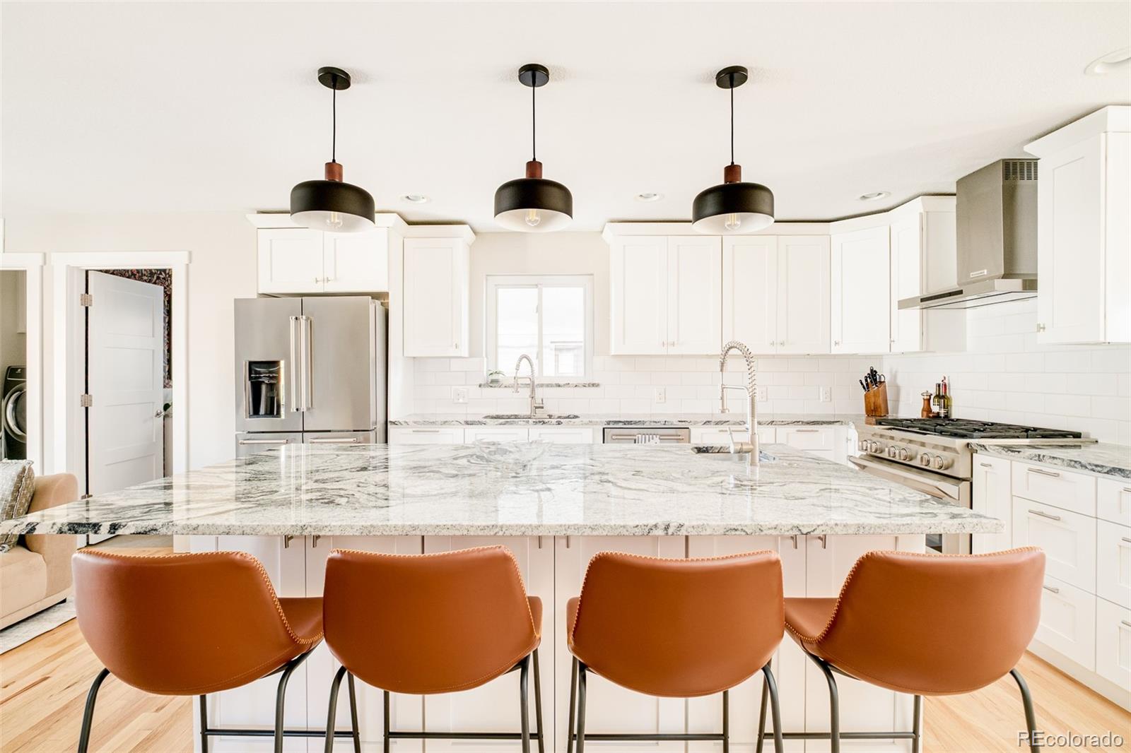 2048 Meade Street Denver, CO 80211 - Photo 7 of 50 a kitchen with stainless steel appliances granite countertop a sink and a cabinets
