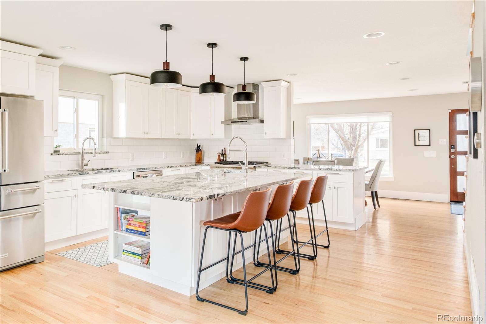 2048 Meade Street Denver, CO 80211 - Photo 8 of 50 a kitchen with stainless steel appliances kitchen island granite countertop a stove a sink and a refrigerator