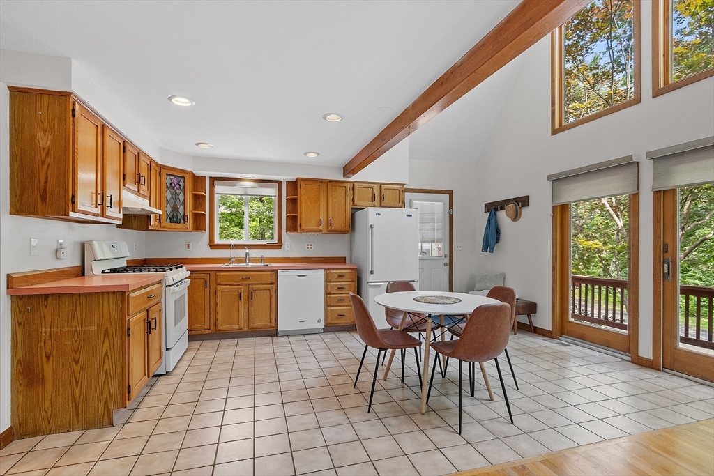 14 Boat House Road Groton, MA 01450 - Photo 11 of 41 a kitchen with a dining table chairs and refrigerator