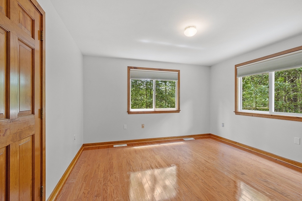 14 Boat House Road Groton, MA 01450 - Photo 14 of 41 an empty room with wooden floor and windows