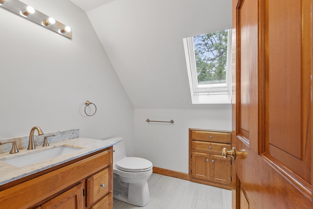 14 Boat House Road Groton, MA 01450 - Photo 23 of 41 a bathroom with a toilet a sink a mirror and a window