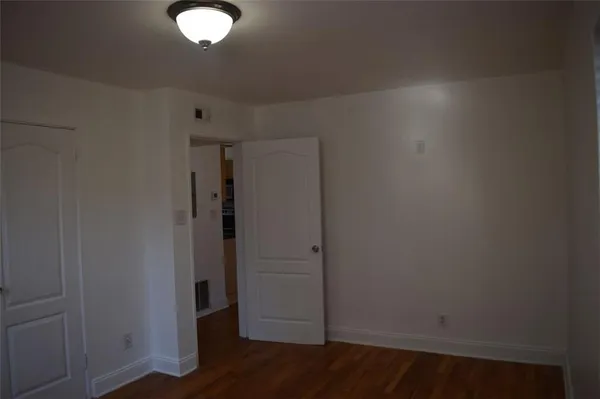 an empty room with wooden floor
