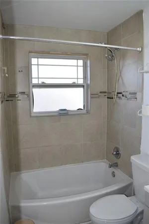 a bathroom with a shower and a bathtub