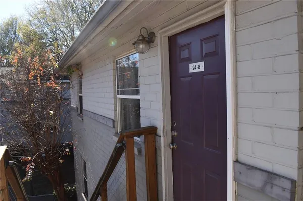 a view of a house with a door and wooden stairs