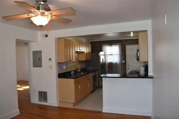 a kitchen with stainless steel appliances granite countertop a sink and a refrigerator