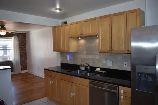 a kitchen with granite countertop wooden cabinets and stainless steel appliances