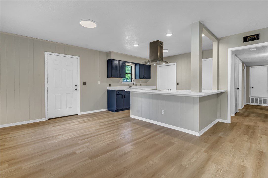 104 North Oneal Street Caldwell, TX 77836 - Photo 13 of 22 a view of kitchen with kitchen island a sink wooden floor and stainless steel appliances