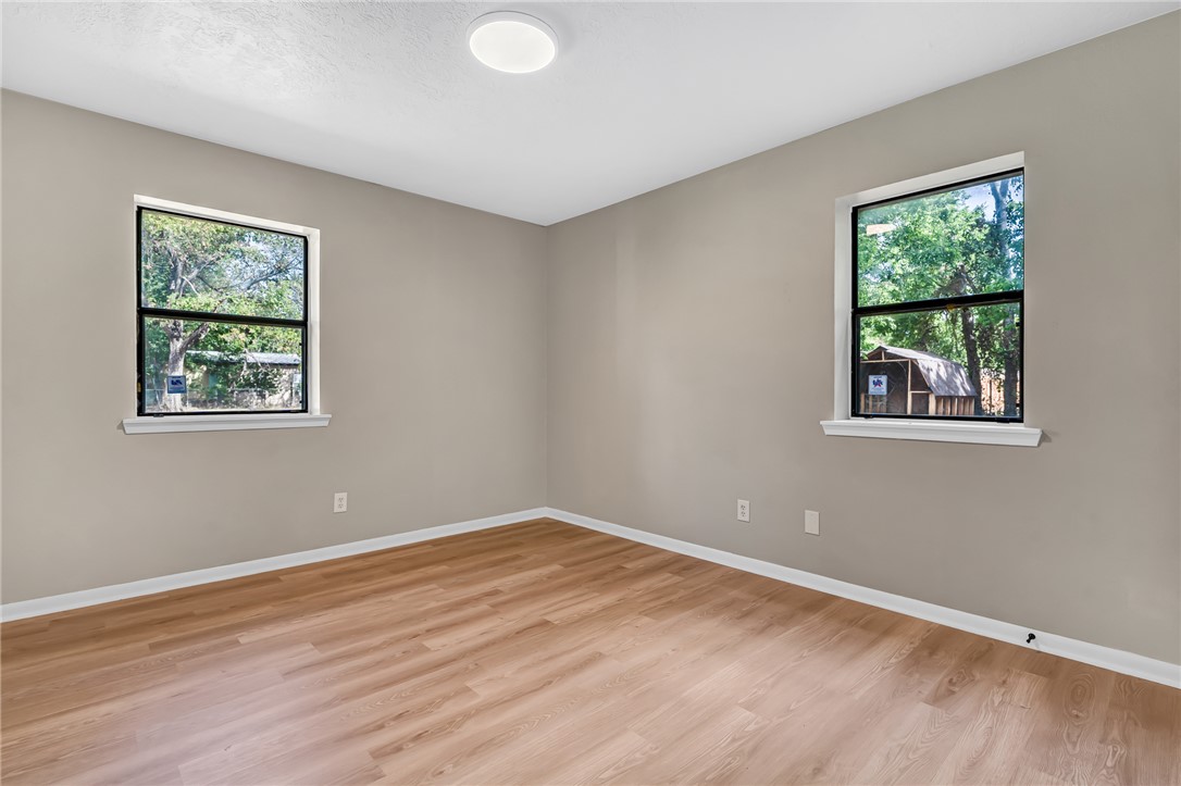 104 North Oneal Street Caldwell, TX 77836 - Photo 16 of 22 a view of an empty room with wooden floor and a window