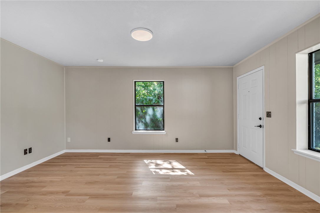 104 North Oneal Street Caldwell, TX 77836 - Photo 7 of 22 wooden floor in an empty room with a window