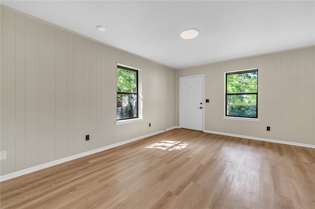 104 North Oneal Street Caldwell, TX 77836 - Photo 8 of 22 an empty room with wooden floor and window