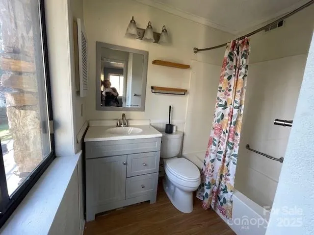 a bathroom with a sink toilet and shower