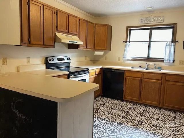 a kitchen with a sink a stove cabinets and wooden floor