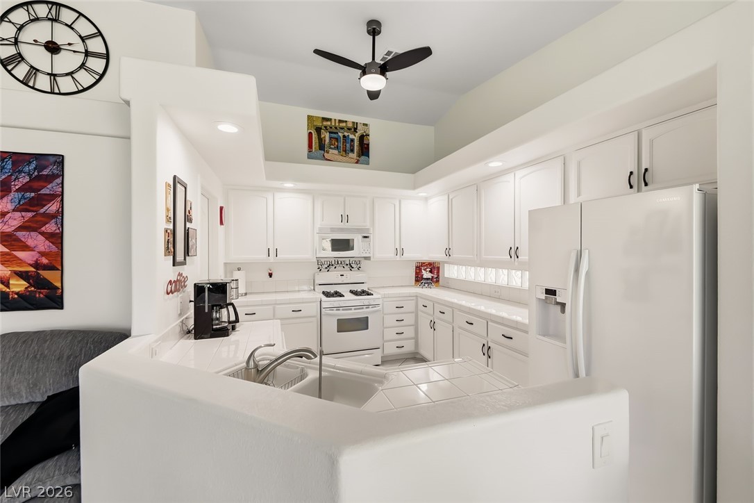 10 Rising Sun Court Henderson, NV 89074 - Photo 10 of 38 Beautiful kitchen with tile countertops, ceiling fan and recessed lighting.