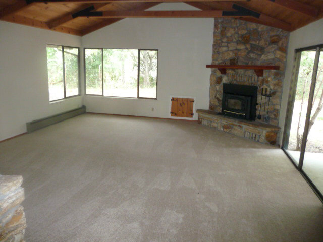310 Rider Ridge Road Santa Cruz, CA 95065 - Photo 2 of 12 an empty room with windows and fireplace