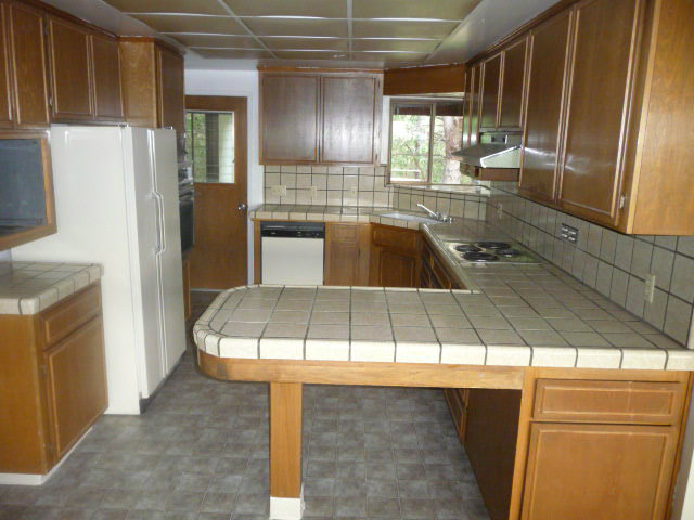 310 Rider Ridge Road Santa Cruz, CA 95065 - Photo 3 of 12 a view of a kitchen with stainless steel appliances granite countertop a sink and a refrigerator