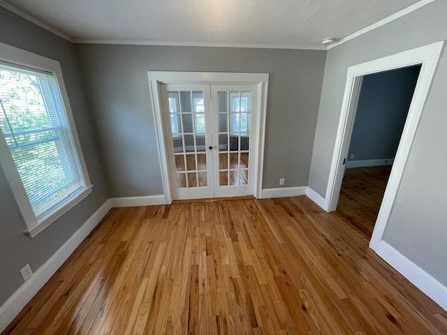 86 Margin Street, Unit 2 Haverhill, MA 01832 - Photo 12 of 28 a view of an empty room with wooden floor and a window