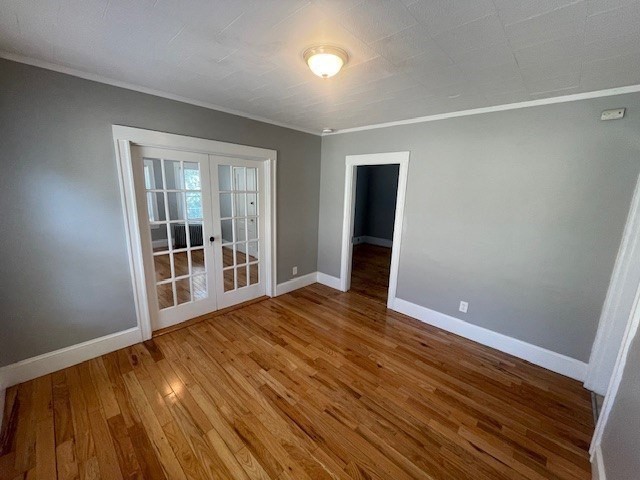 86 Margin Street, Unit 2 Haverhill, MA 01832 - Photo 14 of 28 a view of an empty room with wooden floor and a window