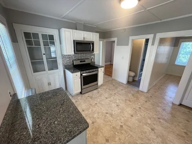 a view of kitchen with sink microwave and refrigerator