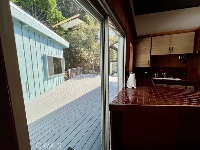 a view of backyard and kitchen with wooden floor