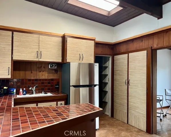 a view of kitchen with refrigerator stove and a sink