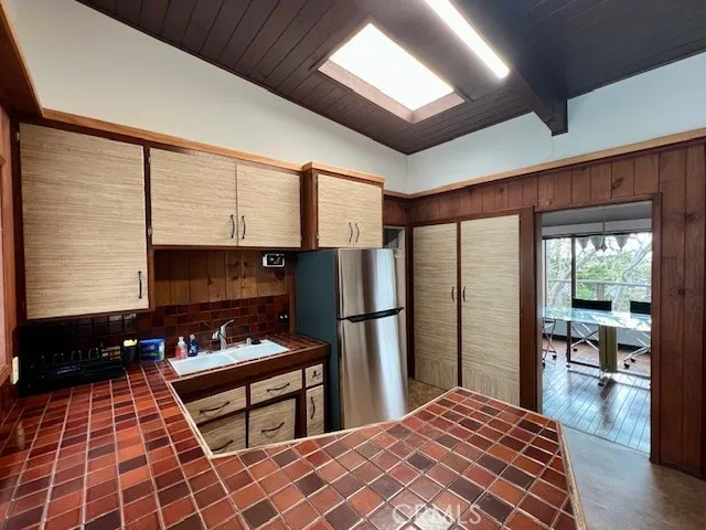 a kitchen with stainless steel appliances a refrigerator and a stove