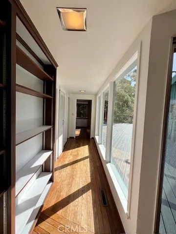 a view of a hallway with wooden floor and staircase