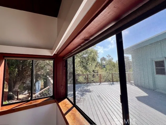 a view of a room with wooden floor and windows
