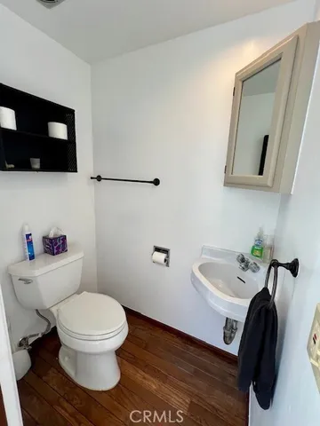 a white toilet sitting next to a bathroom sink